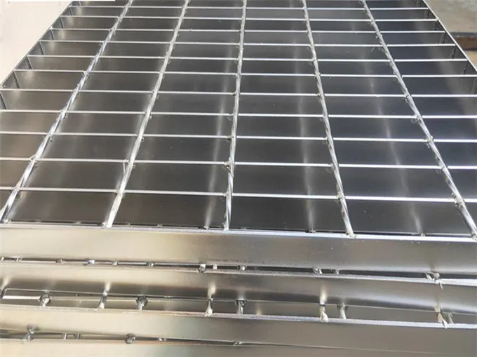 Worker with tape measure checking grating panel