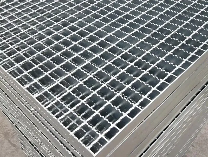 Shipping container being loaded with grating bundles