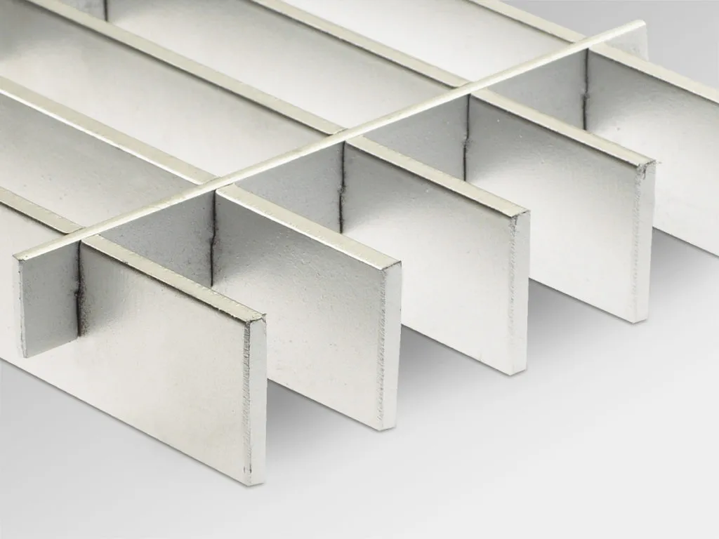 Press-locked steel grating low three-quarter view on light gray studio background; cross bars slotted into bearing bars
