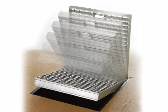 Welded grating stair treads installed on steep industrial steel staircase; side view