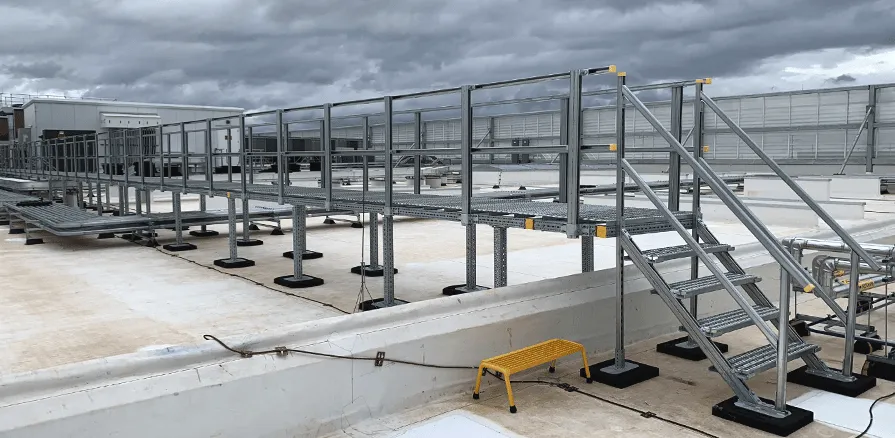 Galvanized steel grating walkway/platform installed inside industrial building; photo taken along the panels