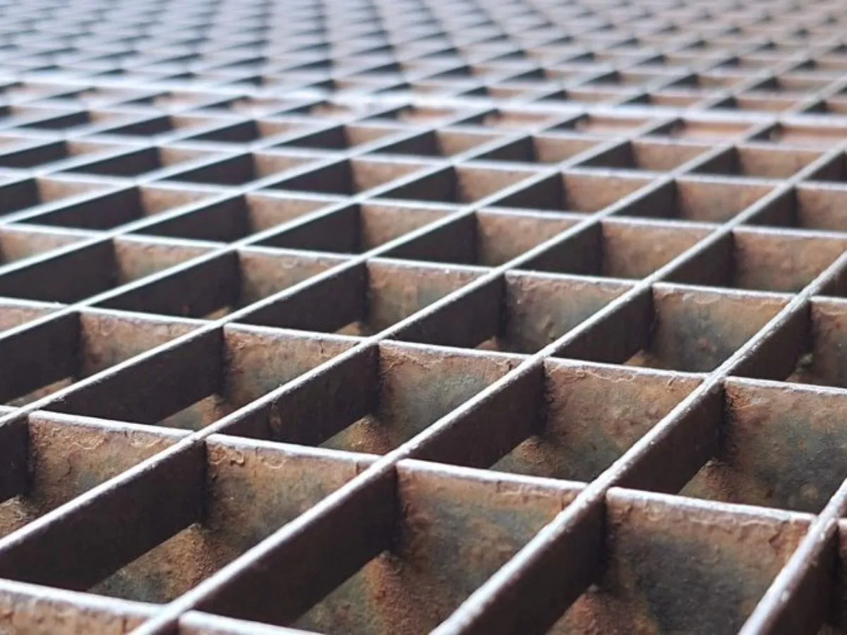 Aerial view of grating platform walkways around large industrial tanks and pipes