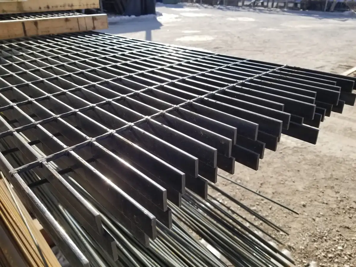 Wide shot of large welded grating platform decks and railed walkways around industrial plant equipment