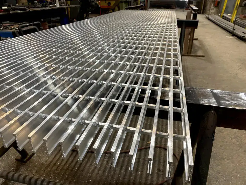 Welded steel bar grating close-up; galvanized; white studio background