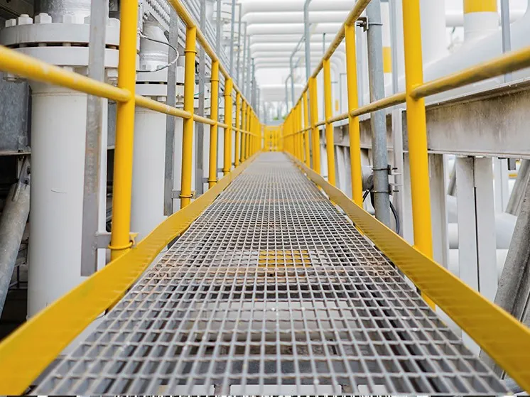 Top-down close view of galvanized welded grating deck; regular repeating mesh texture