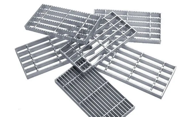 Welded steel bar grating diagonal close-up on white background; galvanized bearing bars with twisted square cross bars