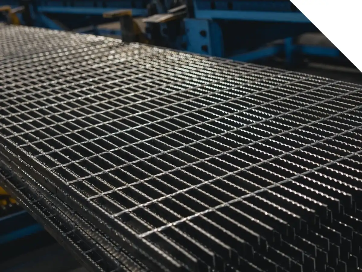 Heavy-duty welded grating panel with deep bearing bars and widely spaced twisted square cross bars; three-quarter view on white background