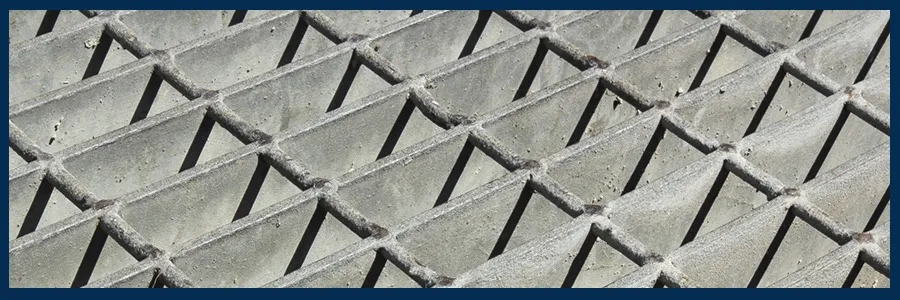 Welded steel grating panel on white background; low three-quarter view with clear splice/joint detail